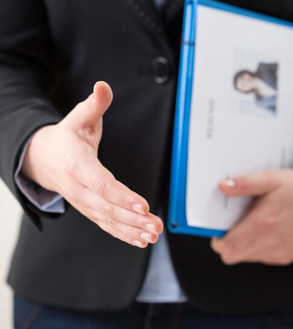 A person holding out their hand for someone to shake.