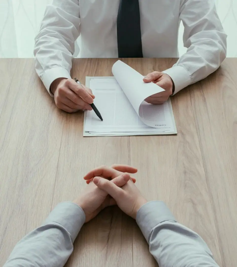 A man is interviewing someone on the table