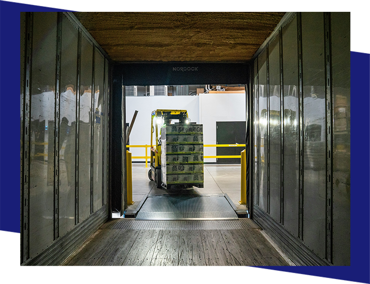 A forklift is moving boxes in the warehouse.