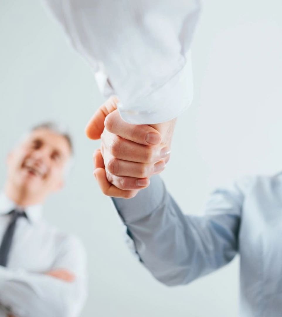 Two men shaking hands in a room.