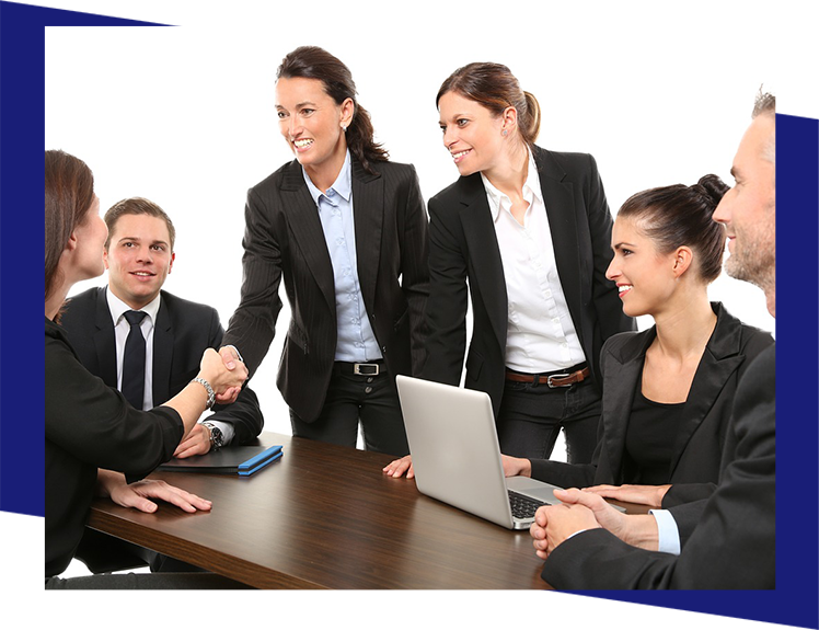 A group of people in suits sitting around a table.