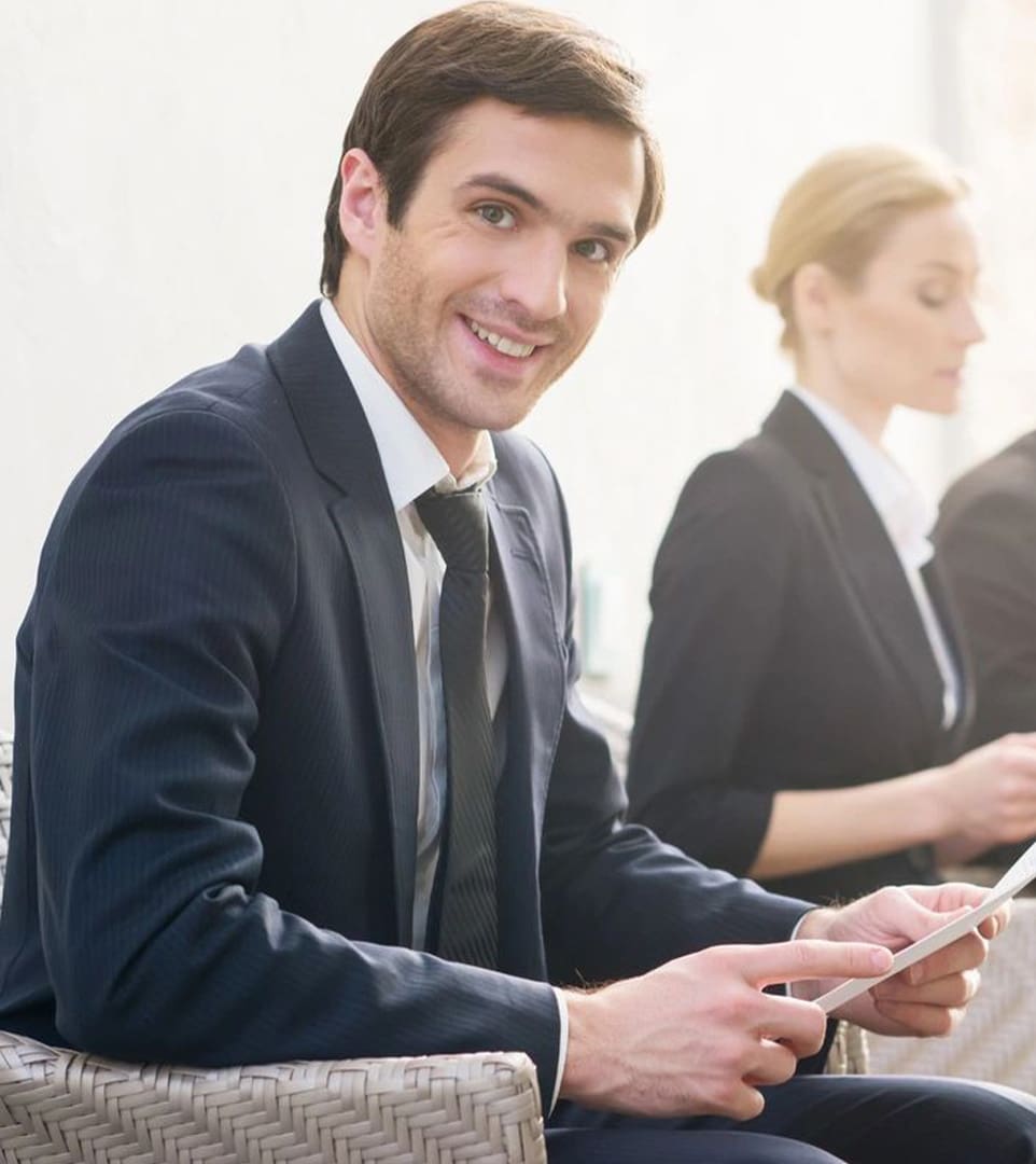 A man sitting in front of two other people.