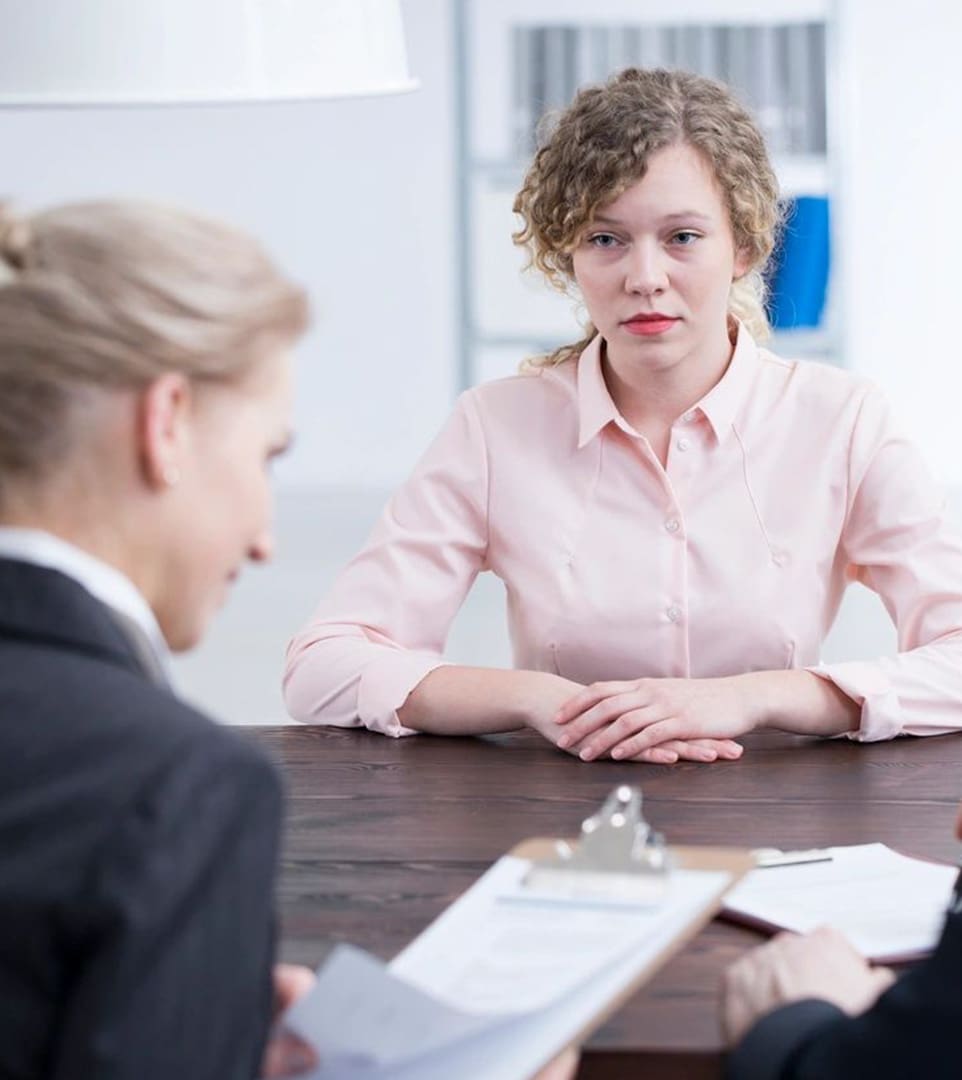 A woman sitting at a table with another person.