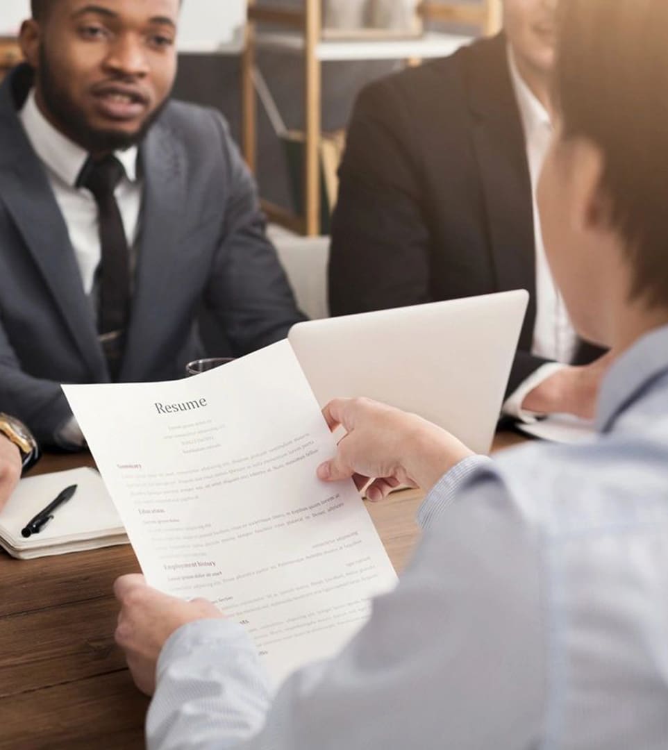 A man in suit and tie holding papers